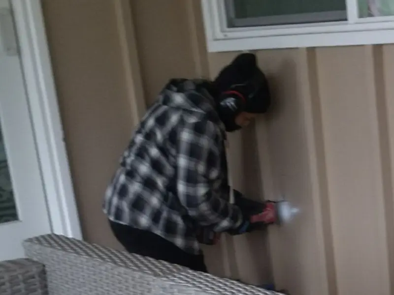 Professional electrician installing an exterior outlet in Kingston